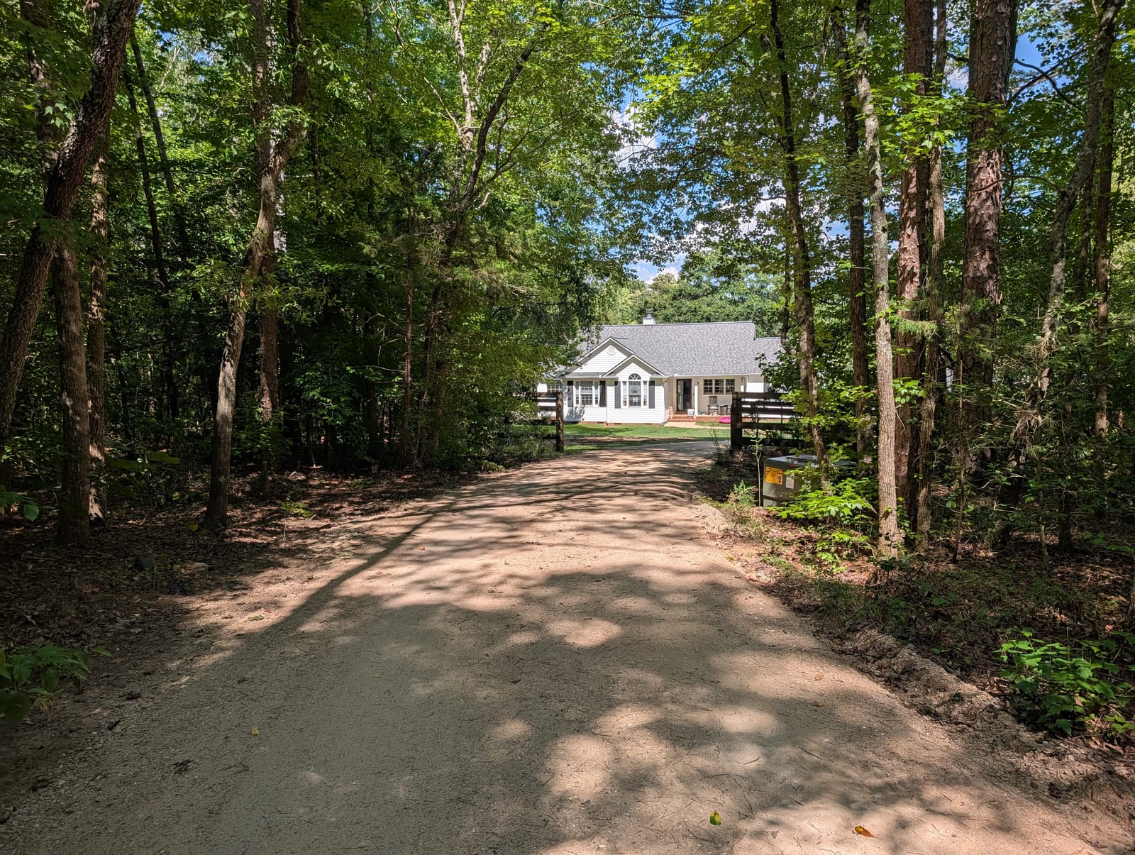 The finished 950-foot gravel driveway, regraded and compacted, looking toward the house